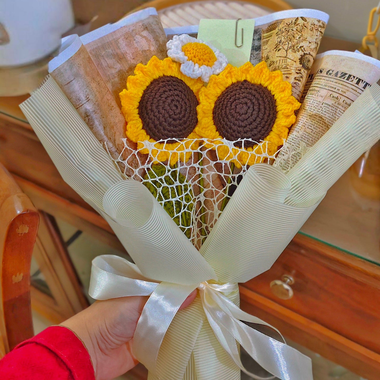 Bouquet of sunflower-shaped cookies wrapped in a decorative paper with a ribbon.