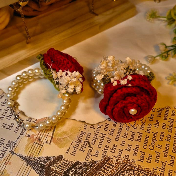 Red flower hair clips with pearl details on a vintage book page with Big Ben model.