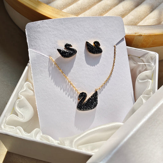 Jewelry set with black Swan-shaped pendant necklace and earrings on a white card.