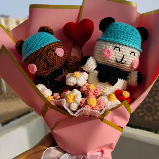 Bouquet of plush toys shaped like animals with a heart and flowers, held against a blurred background.