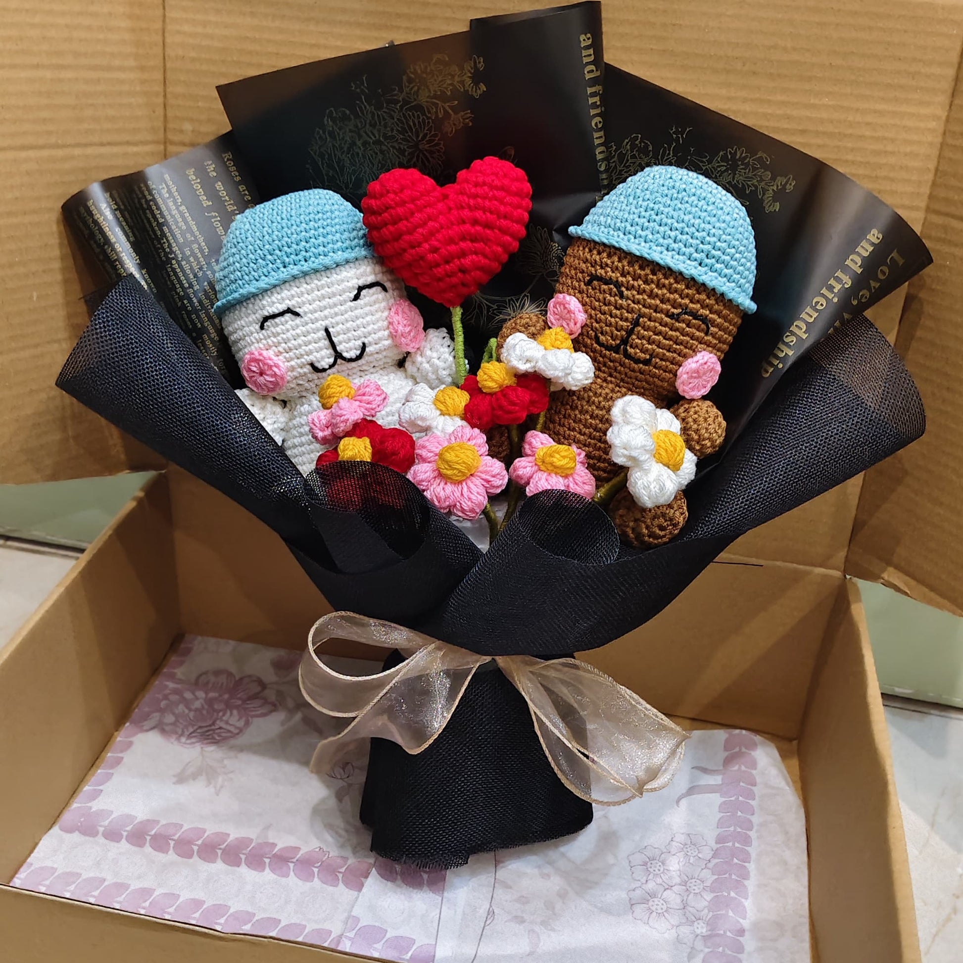 Bouquet of knitted characters in a box