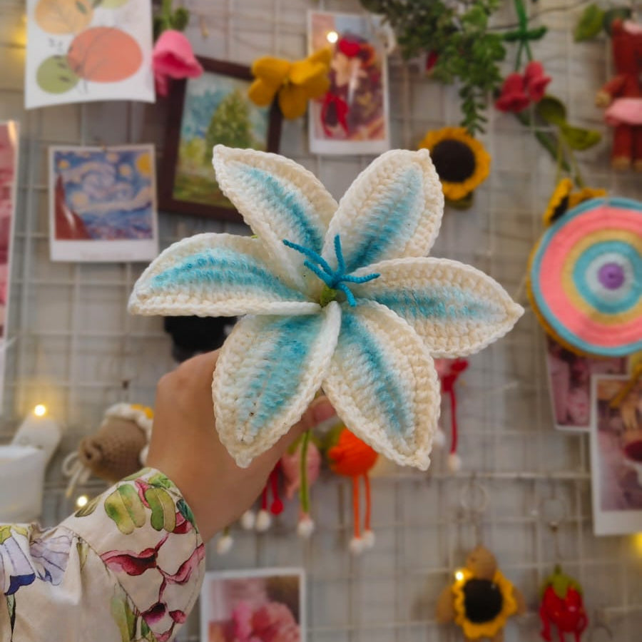 Handmade flower craft held by a person with a 'Bee Art' sign in the background.